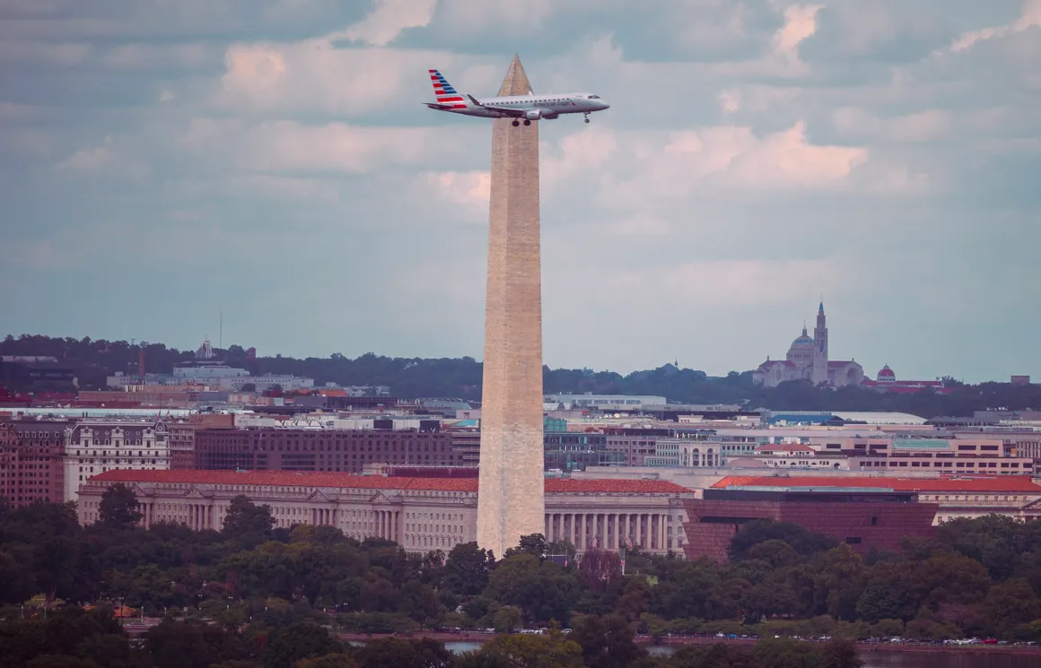 Perfect timing, catching a airplane go in in front of the national monument fly by